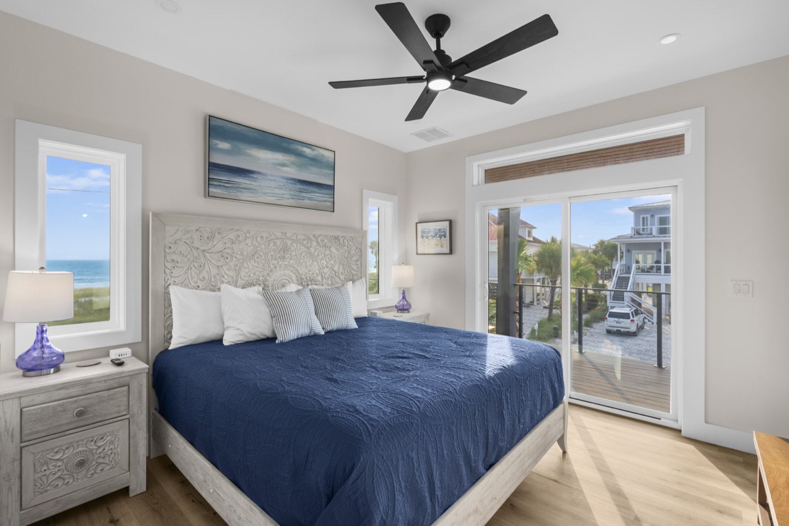 Bedroom with balcony access and coastal community view